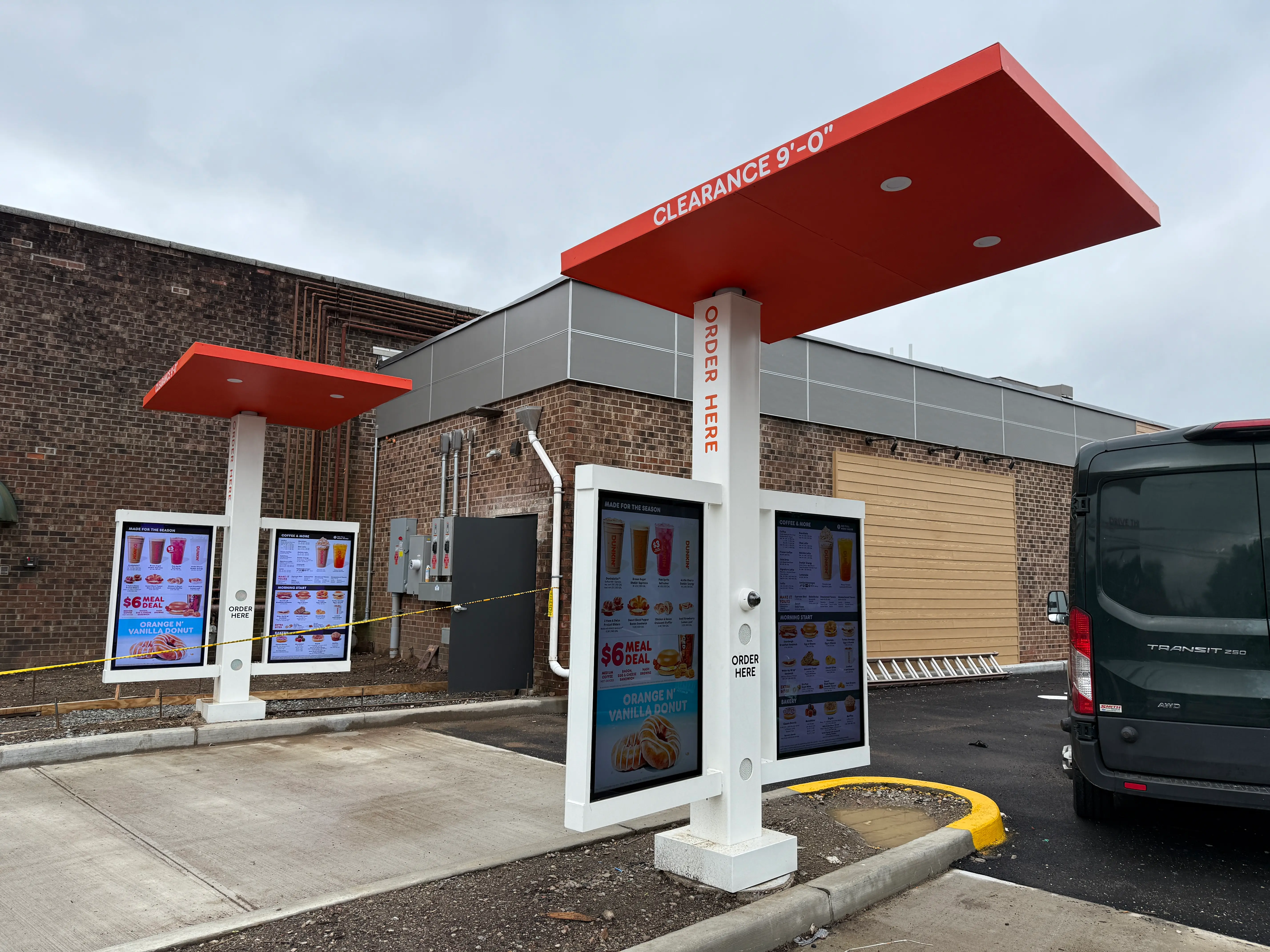 Drive-thru clearance bars and order point signage installed at a commercial restaurant.